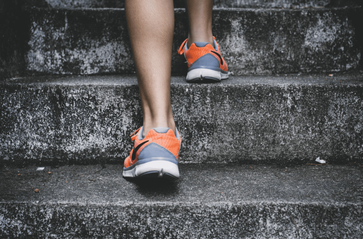 a photo of someones legs running up stairs