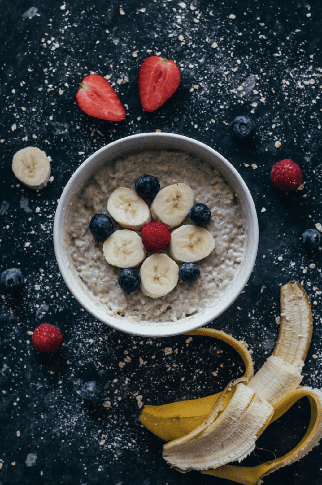 Picture of a bowl of overnight oats on a black countertop
